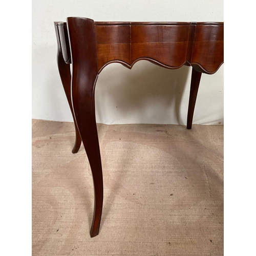 104 - A PAIR OF MAHOGANY SHAPED LEATHER TOPPED COFFEE TABLES, shaped top with leather inset, both standing... 