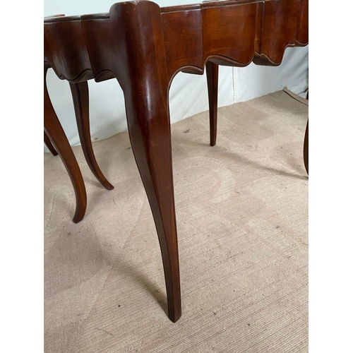 104 - A PAIR OF MAHOGANY SHAPED LEATHER TOPPED COFFEE TABLES, shaped top with leather inset, both standing... 