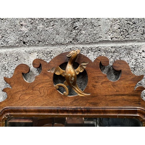 106 - A DECORATIVE MAHOGANY & GILTWOOD WALL MIRROR, of rectangular form, with bevelled glass surrounded by... 