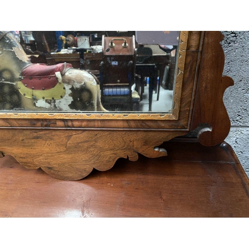 106 - A DECORATIVE MAHOGANY & GILTWOOD WALL MIRROR, of rectangular form, with bevelled glass surrounded by... 