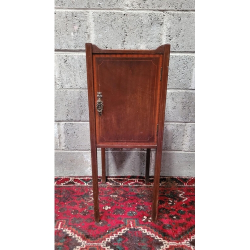 131 - A LATE 19th / EARLY 20TH CENTURY MAHOGANY STRING INLAID CABINET, with brass pull-ring handle to the ... 