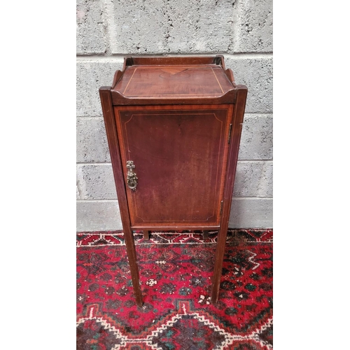 131 - A LATE 19th / EARLY 20TH CENTURY MAHOGANY STRING INLAID CABINET, with brass pull-ring handle to the ... 