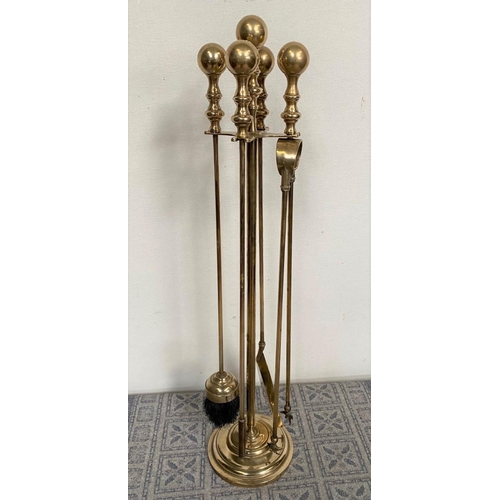 133 - A SET OF FOUR BRASS FIRE IRONS ON STAND, decorative gilt brass, to include poker, shovel, tongs and ... 