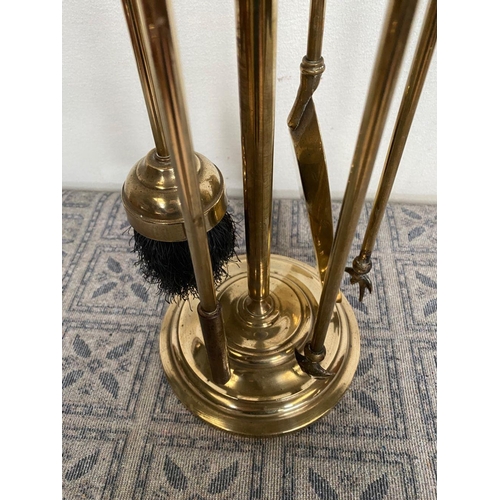 133 - A SET OF FOUR BRASS FIRE IRONS ON STAND, decorative gilt brass, to include poker, shovel, tongs and ... 