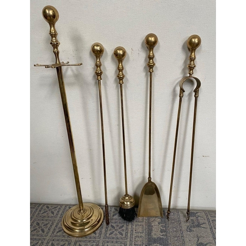 133 - A SET OF FOUR BRASS FIRE IRONS ON STAND, decorative gilt brass, to include poker, shovel, tongs and ... 