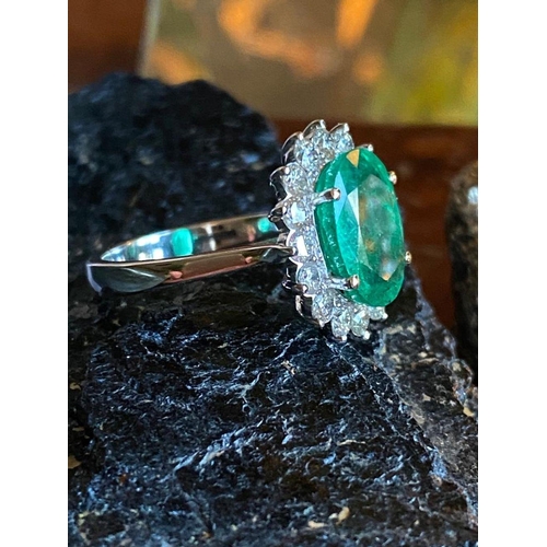 15 - AN EXQUISITE 18CT WHITE GOLD COLUMBIAN EMERALD & DIAMOND CLUSTER RING, natural oval Columbian emeral... 