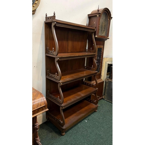 22 - AN ANTIQUE MAHOGANY WATERFALL FLOOR BOOKCASE, with decorative pierced openwork to four graduated she... 