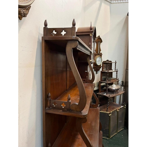 22 - AN ANTIQUE MAHOGANY WATERFALL FLOOR BOOKCASE, with decorative pierced openwork to four graduated she... 