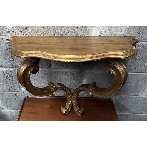 29 - A NAPOLEON III STYLE GILT DEMILUNE SHELF, with serpentine shaped top supported by carved scrolling l... 