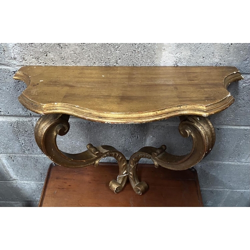 29 - A NAPOLEON III STYLE GILT DEMILUNE SHELF, with serpentine shaped top supported by carved scrolling l... 