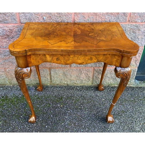 37 - AN ANTIQUE GEORGE II STYLE WALNUT CARD TABLE, with inlay to rectangular lobed hinged top enclosing g... 