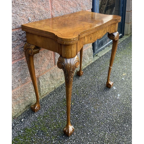 37 - AN ANTIQUE GEORGE II STYLE WALNUT CARD TABLE, with inlay to rectangular lobed hinged top enclosing g... 