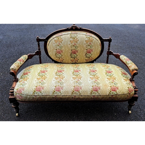 4 - AN ANTIQUE LOUIX XVI STYLE SETEE, upholstered with floral fabric, within carved mahogany frame with ... 