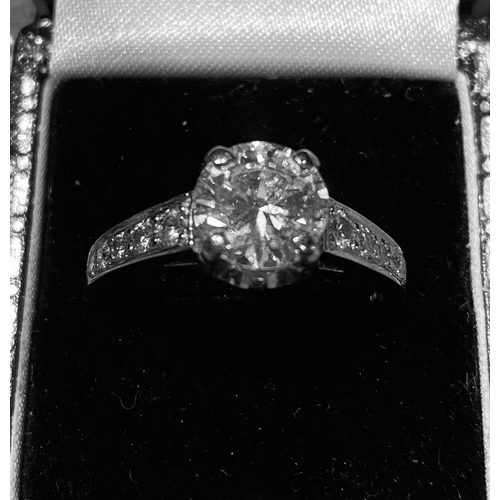 57 - A PLATINUM DIAMOND SOLITAIRE RING, diamond 2.20cts, colour G, clarity VS1, with diamond shoulders. T... 