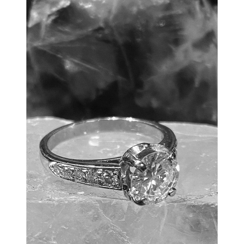 57 - A PLATINUM DIAMOND SOLITAIRE RING, diamond 2.20cts, colour G, clarity VS1, with diamond shoulders. T... 