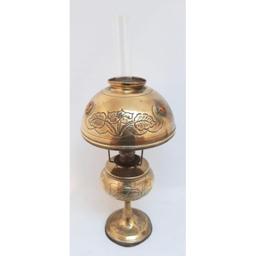 62 - AN ANTIQUE BRASS OIL LAMP, shade with engraved floral design, shade complete with glass chimney, dim... 