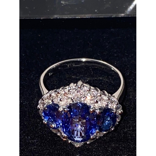 66 - AN ORNATE 18CT WHITE GOLD CEYLON DIAMOND CLUSTER RING, three Ceylon Sapphires surrounded by brillian... 