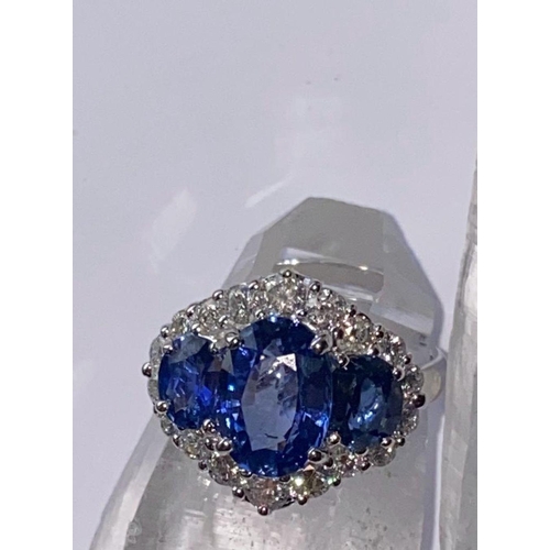 66 - AN ORNATE 18CT WHITE GOLD CEYLON DIAMOND CLUSTER RING, three Ceylon Sapphires surrounded by brillian... 