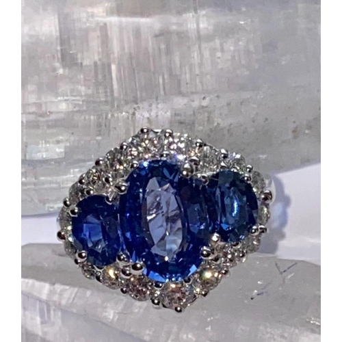 66 - AN ORNATE 18CT WHITE GOLD CEYLON DIAMOND CLUSTER RING, three Ceylon Sapphires surrounded by brillian... 