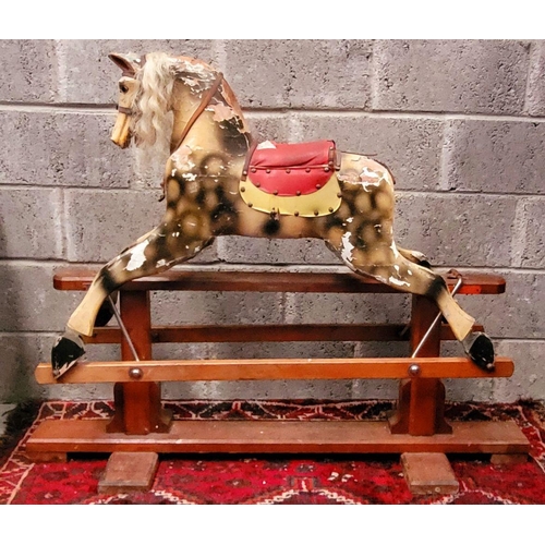 78 - AN EARLY 20TH CENTURY SWING STAND ROCKING HORSE, the carved wooden horse with curly main sits upon a... 