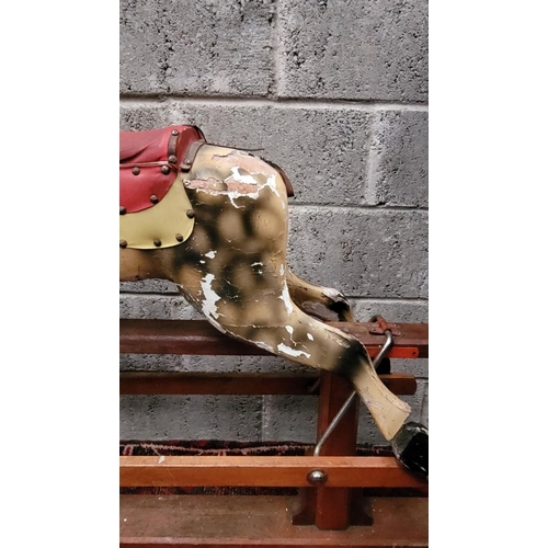 78 - AN EARLY 20TH CENTURY SWING STAND ROCKING HORSE, the carved wooden horse with curly main sits upon a... 