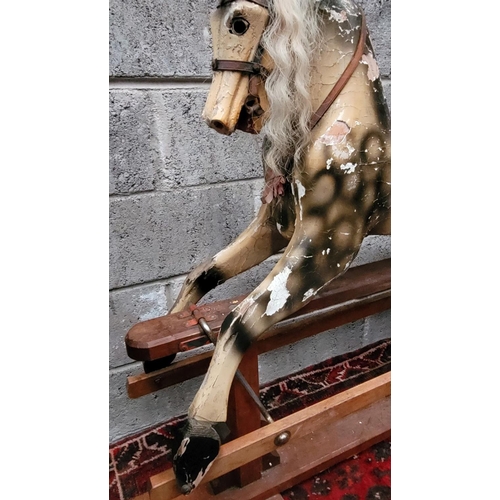 78 - AN EARLY 20TH CENTURY SWING STAND ROCKING HORSE, the carved wooden horse with curly main sits upon a... 