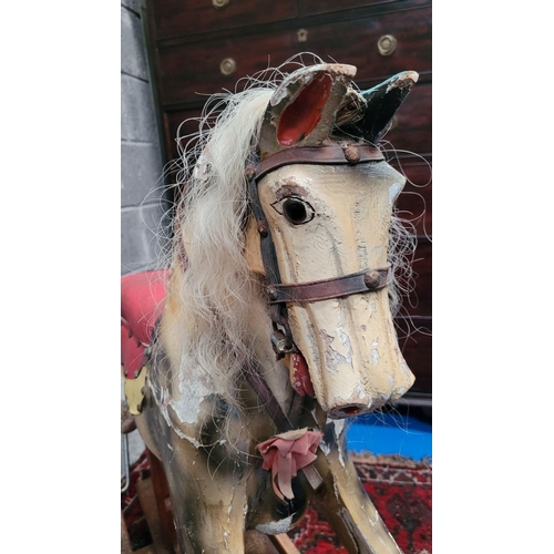 78 - AN EARLY 20TH CENTURY SWING STAND ROCKING HORSE, the carved wooden horse with curly main sits upon a... 