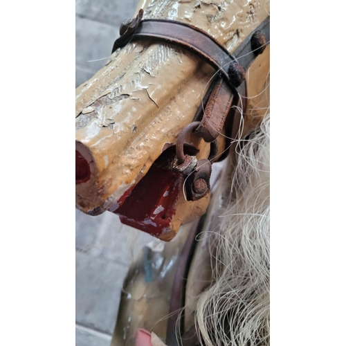 78 - AN EARLY 20TH CENTURY SWING STAND ROCKING HORSE, the carved wooden horse with curly main sits upon a... 