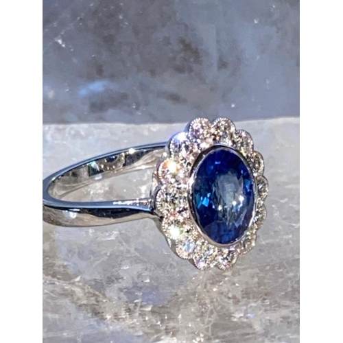 85 - A STRIKING 18CT WHITE GOLD CEYLON SAPPHIRE & DIAMOND CLUSTER RING, in a rubover setting, Ceylon Sapp... 