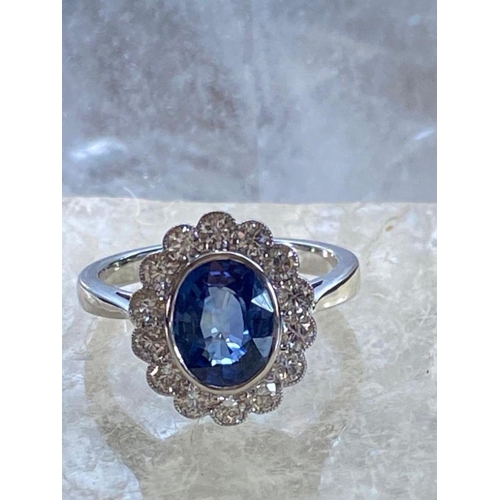 85 - A STRIKING 18CT WHITE GOLD CEYLON SAPPHIRE & DIAMOND CLUSTER RING, in a rubover setting, Ceylon Sapp... 