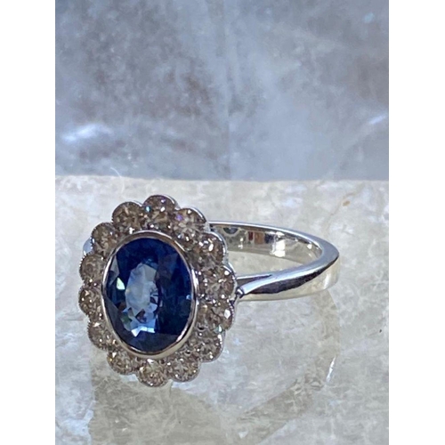 85 - A STRIKING 18CT WHITE GOLD CEYLON SAPPHIRE & DIAMOND CLUSTER RING, in a rubover setting, Ceylon Sapp... 