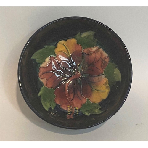 96 - A VINTAGE MOORCROFT HIBISCUS PATTERN BOWL, circular body with raised base, finely decorated with dee... 