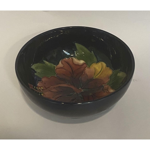 96 - A VINTAGE MOORCROFT HIBISCUS PATTERN BOWL, circular body with raised base, finely decorated with dee... 