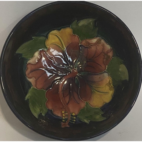 96 - A VINTAGE MOORCROFT HIBISCUS PATTERN BOWL, circular body with raised base, finely decorated with dee... 