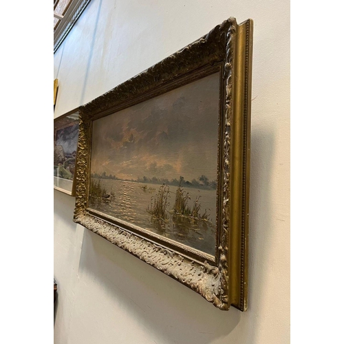 97 - A LATE 19TH/EARLY 20TH CENTURY GILT FRAMED OIL ON CANVAS, depicting lake/river landscape, signed ind... 