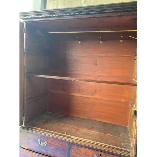 240 - A FINE ANTIQUE MAHOGANY TWO DOOR LINEN PRESS, with dentil cornice, two panelled doors above three dr... 