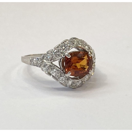 1 - AN EXCEPTIONAL ORANGE CITRINE AND DIAMOND WHITE GOLD CLUSTER RING, oval cut orange citrine in four p... 