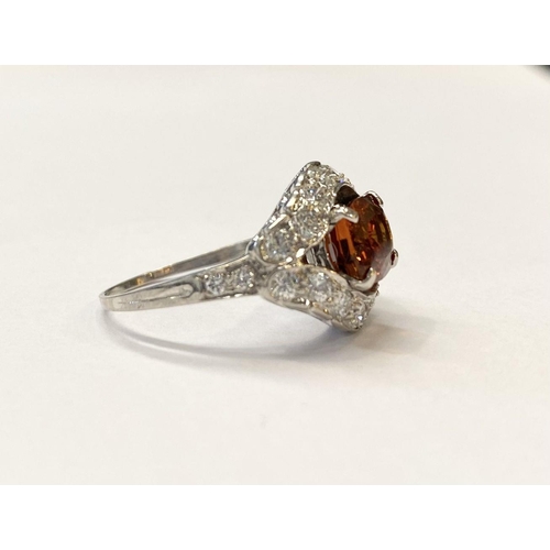 1 - AN EXCEPTIONAL ORANGE CITRINE AND DIAMOND WHITE GOLD CLUSTER RING, oval cut orange citrine in four p... 