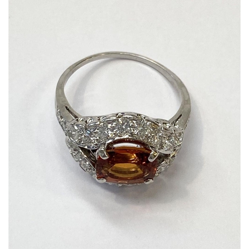 1 - AN EXCEPTIONAL ORANGE CITRINE AND DIAMOND WHITE GOLD CLUSTER RING, oval cut orange citrine in four p... 