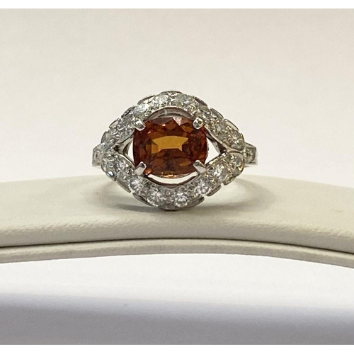 1 - AN EXCEPTIONAL ORANGE CITRINE AND DIAMOND WHITE GOLD CLUSTER RING, oval cut orange citrine in four p... 