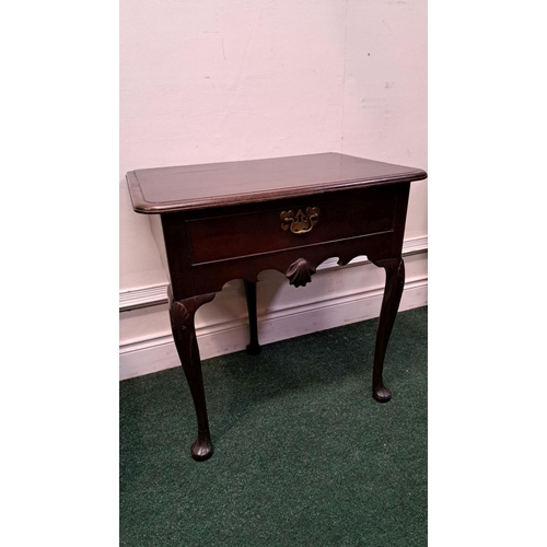 10 - AN IMPORTANT IRISH QUEEN ANNE SIDE TABLE with original brass handle and clam cartouche centre; wave ... 