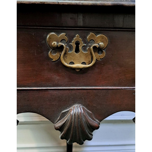 10 - AN IMPORTANT IRISH QUEEN ANNE SIDE TABLE with original brass handle and clam cartouche centre; wave ... 