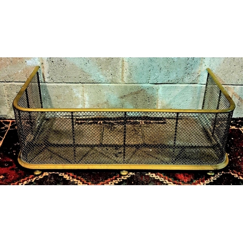 161 - A LATE VICTORIAN BRASS AND IRON FIRE FENDER brass rails and iron mesh, on brass bun feet; NOTE: dama... 