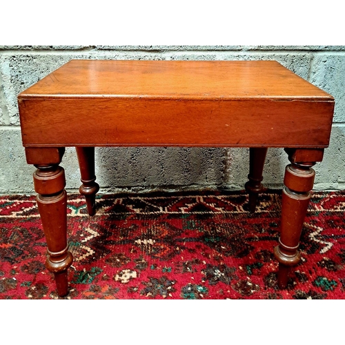 162 - A VICTORIAN BIDET BENCH standing on tapered baluster legs; bench piece removable to reveal slot for ... 