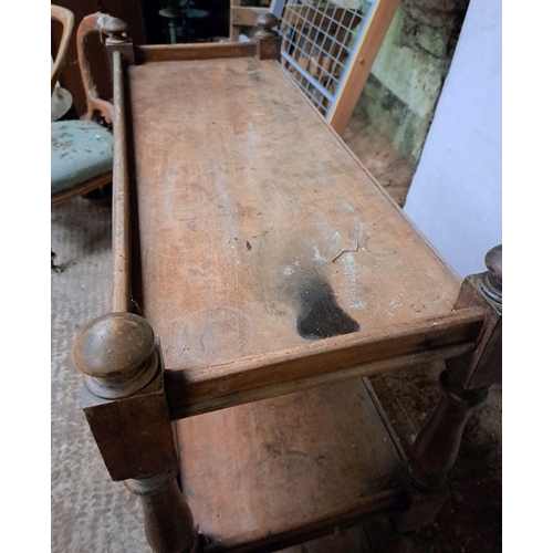 169 - A VICTORIAN MAHOGANY THREE-TIER DUMBWAITER topped with newels on block and baluster columns; in need... 