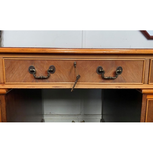 17 - AN EXCELLENT KEYHOLE/PEDESTAL DESK, with leather inset to top above nine panelled drawers with brass... 