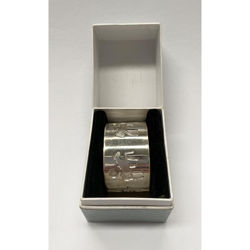 226 - AN IRISH SILVER NAPKIN RING, made by Michael Hillier of Dublin, decorated with relief designs surrou... 