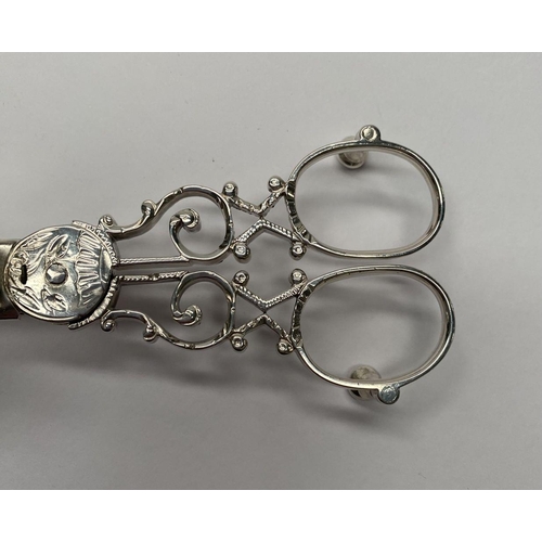 23 - A GEORGE III SILVER CANDLE SNUFFER, Maker John Booth, London, 1767. With oval handles and attached r... 