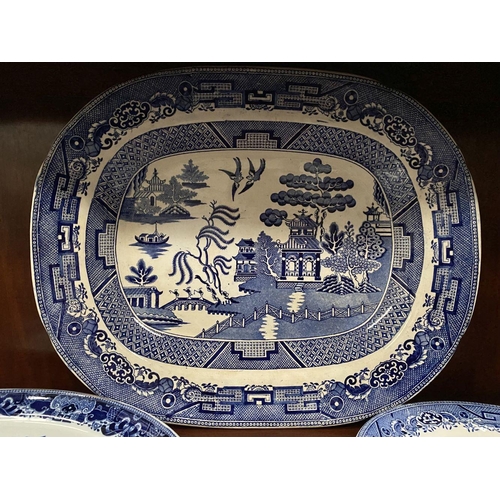 230 - THREE BLUE AND WHITE SERVING DISHES, one Copland, each finely decorated in the Blue Willow pattern; ... 