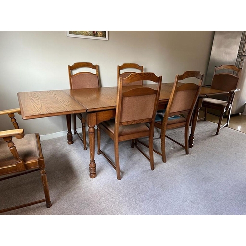 232 - A VINTAGE OAK DRAW-LEAF/EXTENDABLE DINING TABLE on turned legs; note damage to the finish on top of ... 